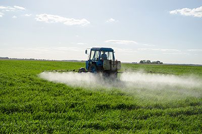 tractor spraying a field